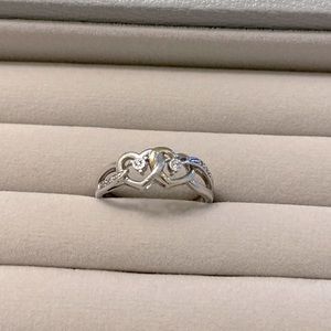 10K White Gold plated heart shaped ring with diamond accents.